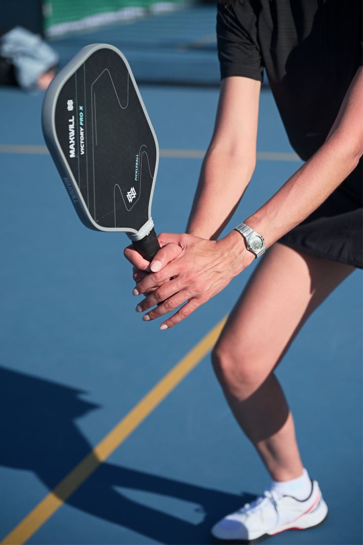 Swinging a paddle on the pickleball court
